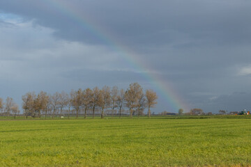 Rainbow in a flatland landscape in the autumn