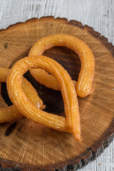 Turkish tulumba halka dessert / ring dessert on wooden table.