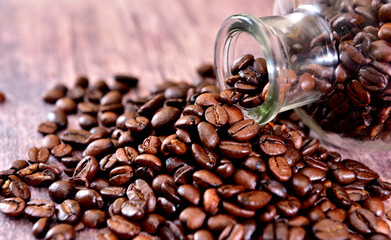 Coffee beans coming out of the glass bottle