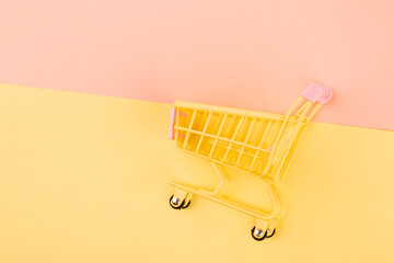 Yellow empty shopping cart. Shopping concept.