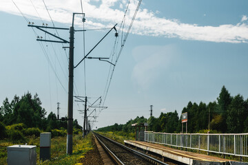 railway tracks in the middle of a field on a sunny summer day
