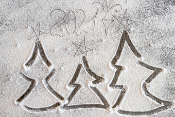 Christmas trees painted on flour. new year 2021
