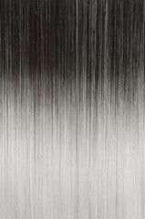 close up of texture of single piece clip in straight black to ash blonde ombre style synthetic hair extensions © Sixsmith