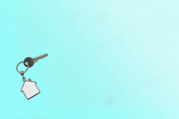 silver house - keychain and key on a blue background