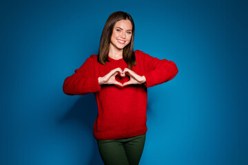 Fototapeta premium Portrait of her she nice attractive pretty lovely lovable cheerful cheery amorous affectionate girl showing heart shape Cupid date isolated bright vivid shine vibrant blue color background