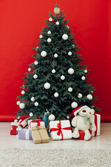 Fototapeta na wymiar Christmas tree pine with gifts New Year red decor house