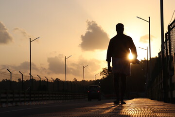 Fototapeta premium silhouette of a person walking on the sunset