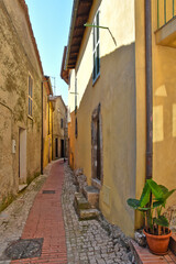 Fototapeta na wymiar A small road crosses the old buildings of Prossedi, a medieval village in the Lazio region, Italy.