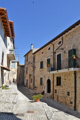 A small road crosses the old buildings of Prossedi, a medieval village in the Lazio region, Italy.