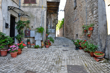 Fototapeta na wymiar A small road crosses the old buildings of Prossedi, a medieval village in the Lazio region, Italy.