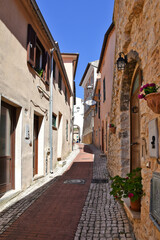 A small road crosses the old buildings of Prossedi, a medieval village in the Lazio region, Italy.