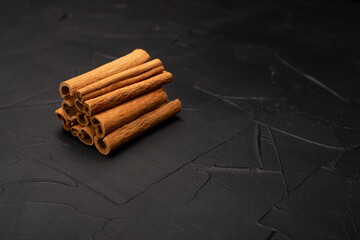 cinnamon sticks on black background