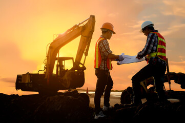 Silhouette Teams of Business Engineers looking for blueprints in construction sites through blurry...