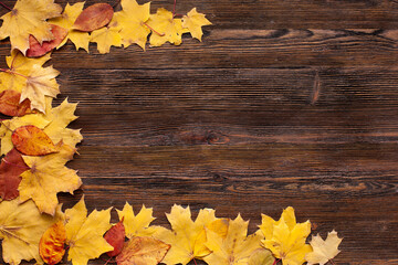 Naklejka na ściany i meble Autumn maple leaves on wood background