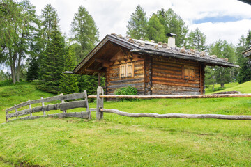 wooden hut and fence  in Alpe di Siusi or Seiser Alm,   Dolomites Alps, South tyrol, Italy.
