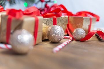 balls and golden gifts with red ribbons. Christmas background.