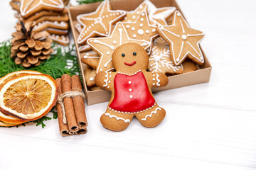 Box with tasty christmas cookies, gingerbread man, oranges, Xmas tree