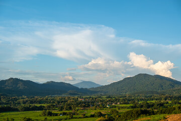 The white clouds have a strange shape and moutain.