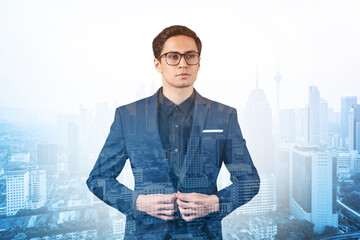 Young handsome businessman in suit and glasses dreaming about new career opportunities after MBA...