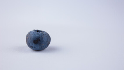 Close-up of ripe juicy blueberries on a white background.
