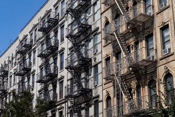 Obraz premium Row of Old Apartment Buildings in the East Village of New York City with Fire Escapes