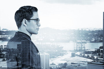 Fototapeta na wymiar Young handsome businessman in suit and glasses dreaming about new career opportunities after MBA graduation. Singapore on background. Double exposure.