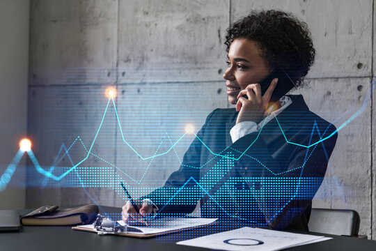 Businesswoman speaks phone and stock market financial graph hologram. Double exposure. Company statistics study concept.