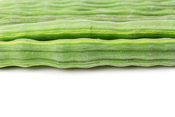 Fototapeta premium Sliced cut Moringa oleifera (drum stick) pods isolated on white background.
