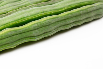 Sliced cut Moringa oleifera (drum stick) pods isolated on white background.