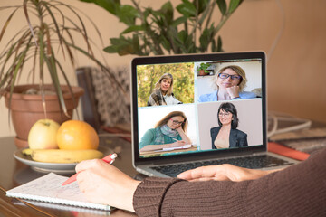 Fototapeta na wymiar A group of women communicate on the Internet via teleconferences at home. Concept of solving operational issues