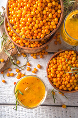 Hot autumn organic drink. Healthy diet beverage, immunity buster food. Sea buckthorn tea with orange and honey in a glass cups. White background copy space