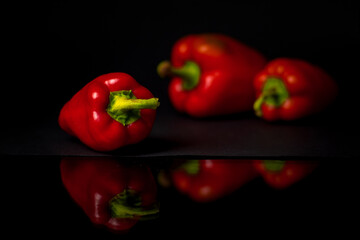 Red peppers on black background
