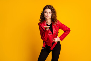 Portrait of coquette girl send hand air kiss wear leather pants trousers isolated over shine color...