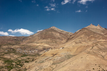 Fototapeta na wymiar A village on the slopes of a Himalayan mountain in the Spiti valley