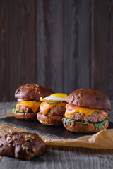 A set of three different mini burgers.