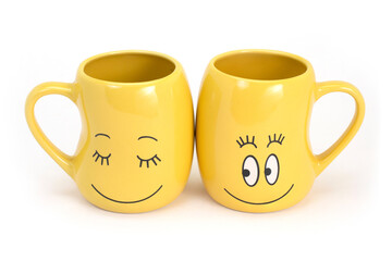 two funny smiling cups isolated on white