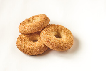 Close up. Round, freshly baked shortbread biscuits with sugar sprinkles stacked together isolated on a white background. The concept of tasty and junk food.