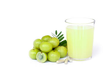  Amla or Indian gooseberry fruits ( phyllanthus emblica ) with capsule and glass of gooseberry juice isolated on white background. 
