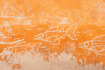 des poisson gravés dans le mur