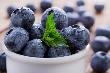 Blueberries with mint leaf in water drops close-up