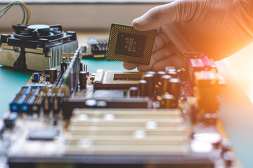 Technician man epair computer, work on motherboard 
