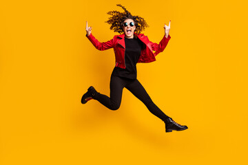Fototapeta na wymiar Full length body size view of pretty energetic cheerful wavy-haired girl jumping showing horn sign fooling isolated on bright color background