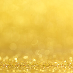 Gold Festive Christmas background. Abstract twinkled bright background with bokeh defocused golden lights