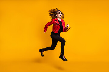 Full length body size view of pretty trendy active cheerful wavy-haired girl jumping running isolated on bright yellow color background