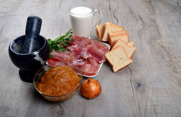 Ingredients for fish cutlets, meatball or fish croquettes. Fresh fish meat, bread, milk, onion, fish caviar and parsley, salt. Copy space