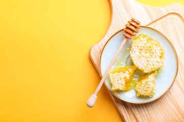 Golden cut honeycomb with a wooden spoon