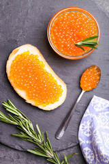 Sandwich with red chum salmon caviar and rosemary