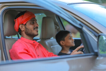 young indian farmer and little child with car