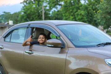 Cute Indian child showing face expression in car