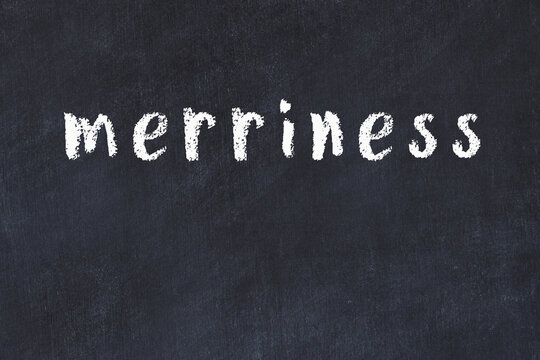 Black chalkboard with inscription merriness on in